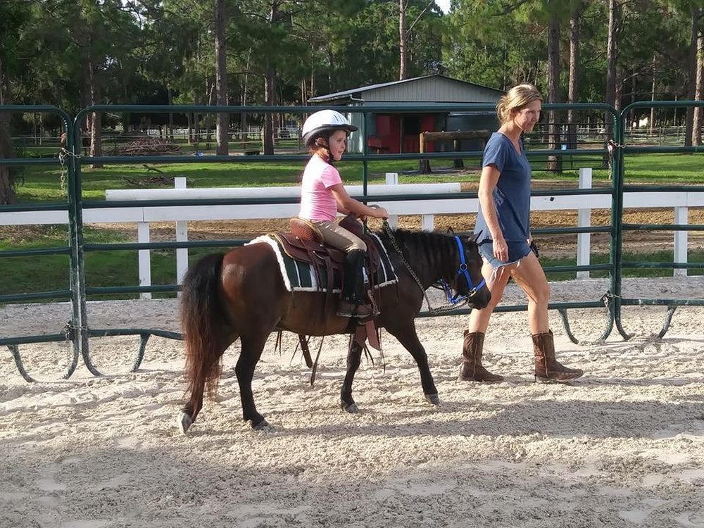 Audrey riding Elvis on the lead line in the arena